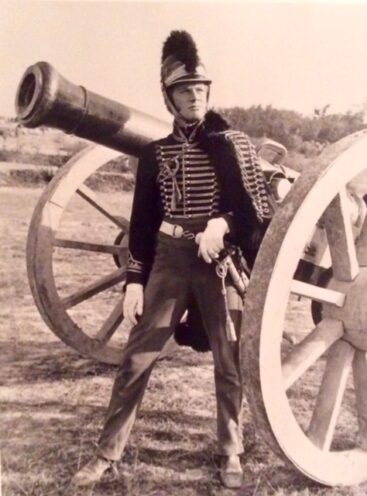 Actor Richard Heffer standing beside a cannon used in the 1970 film Waterloo